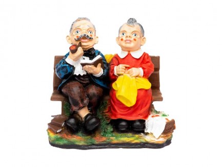 Bunicul si bunica stau pe banca decor gradina